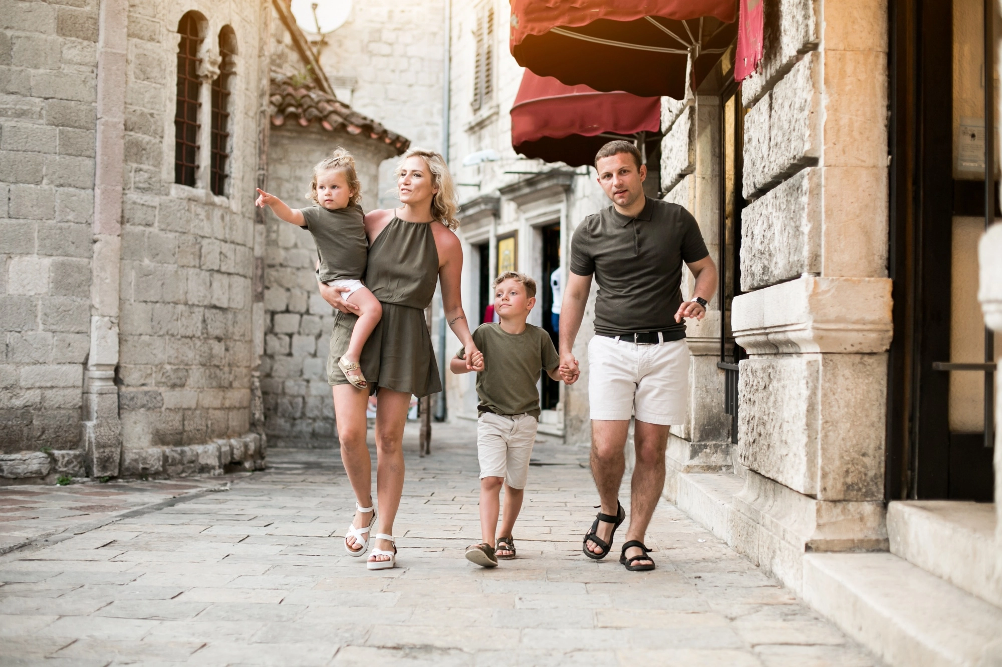 A family visiting the streets of a historic village near Venice—a family-friendly experience accessible from the Titian Inn Hotel Venice Airport